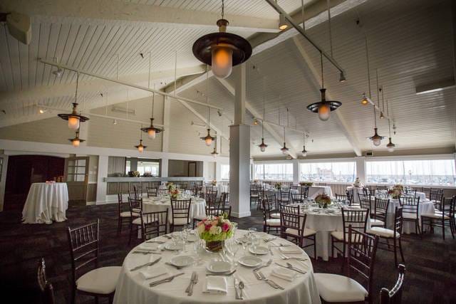 Elegant Bluewater Grill event space with round tables, ideal for weddings and corporate meetings.
