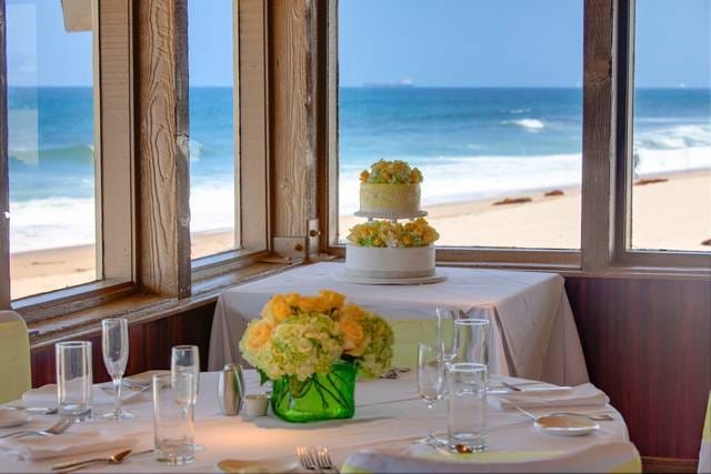 Dining room with ocean view, elegant table setting for romantic events at Chart House Redondo Beach.