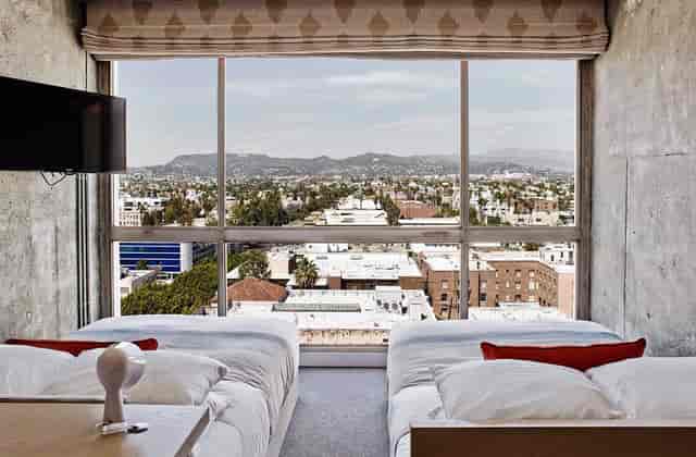 Modern hotel room with large windows, ideal for corporate retreats or events in Hollywood Hills.