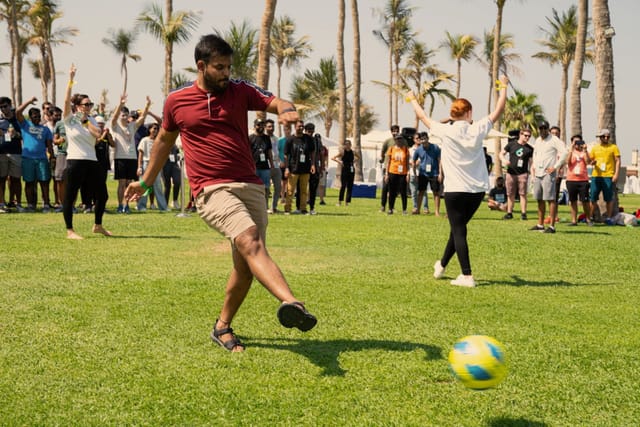 Outdoor team-building soccer event at The Arctic Express Retreat, lush tropical backdrop.