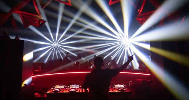 DJ performing at Sound Nightclub's outdoor patio, vibrant nightlife, immersive event.
