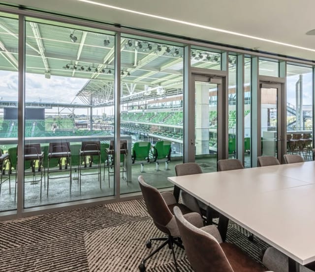 Modern meeting space with large windows at Q2 Stadium for corporate events and team meetings.