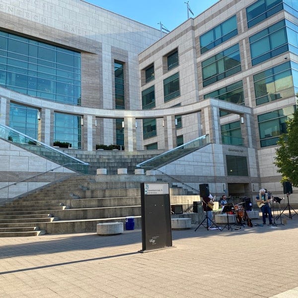 Genentech Hall outdoor event space with modern architecture and live music for gatherings.