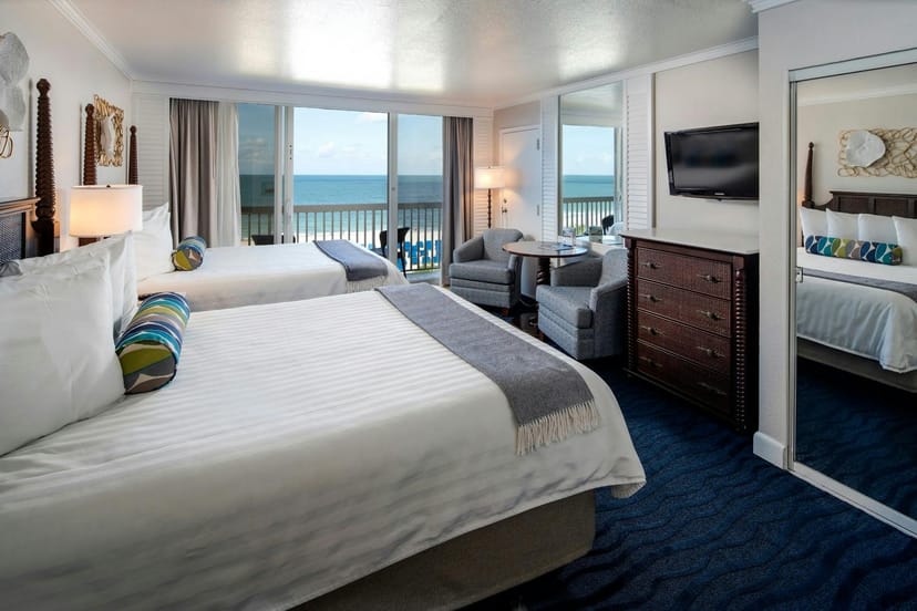 Hotel room at TradeWinds Resort with two beds; ideal for business and leisure events.