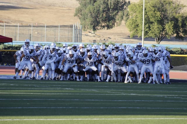 Cerritos College athletes prepare for a high-energy game, showcasing teamwork and excitement.