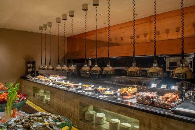 "Elegant food display at il Mare, Hotel Mulia event, featuring stylish pendant lighting."