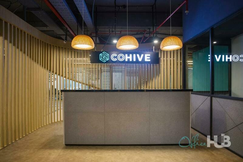 Modern coworking space reception with warm lighting, ideal for events and meetings.