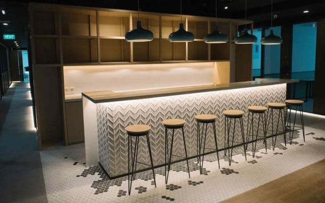 Modern co-working bar area in Menara Mandiri for networking and social events.