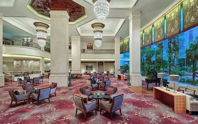 Elegant hotel lobby at Shangri-La Jakarta with chandeliers, perfect for receptions.