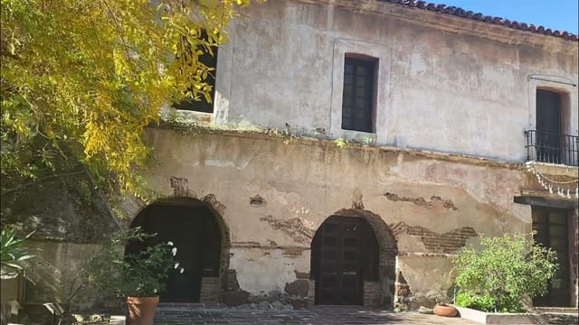 El Molino Viejo Museum outdoor venue with rustic stone architecture for unique events.