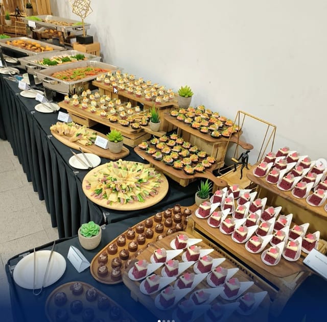 Buffet table with gourmet hors d'oeuvres and desserts at CaterCo event planning.