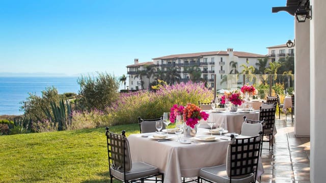 Outdoor event setup at Terranea Resort with vibrant floral centerpieces and ocean view.