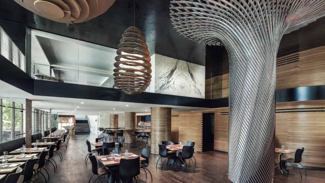 Modern dining space at The Watergate Hotel, featuring a spiral column for upscale events.