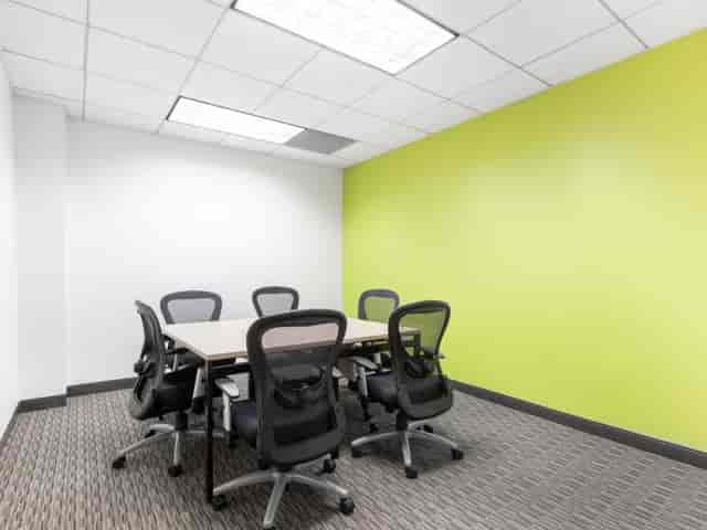 Modern meeting room with a circular table, perfect for team brainstorming sessions.
