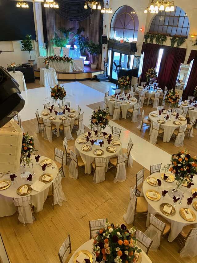 Elegant event space at The Granada with cream tablecloths and gold accents for weddings.