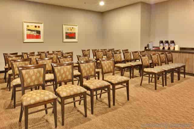 Meeting room at Holiday Inn LAX with upholstered chairs, ideal for seminars or presentations.