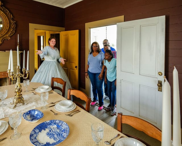 Historical museum at George Ranch with host in period attire for immersive events.