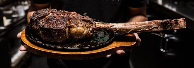 Tomahawk steak showcase for upscale events and interactive dining experiences.