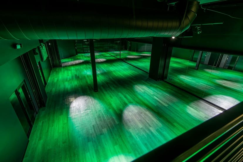 Versatile event space at RRB Studios with green lighting, ideal for corporate and social events.