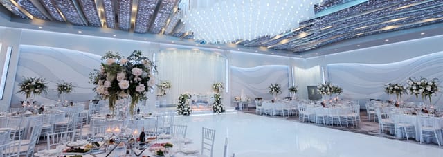 Elegant event hall with glossy dance floor, perfect for weddings and galas.