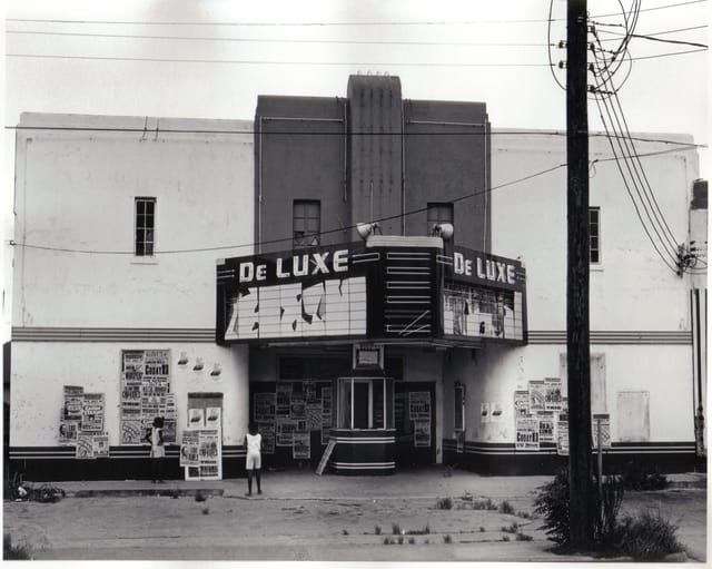 Vintage DeLUXE Theater with art deco facade, ideal for themed events and film screenings.