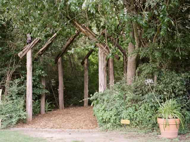 "Bunk House archway with wooden beams, perfect for weddings and retreats."
