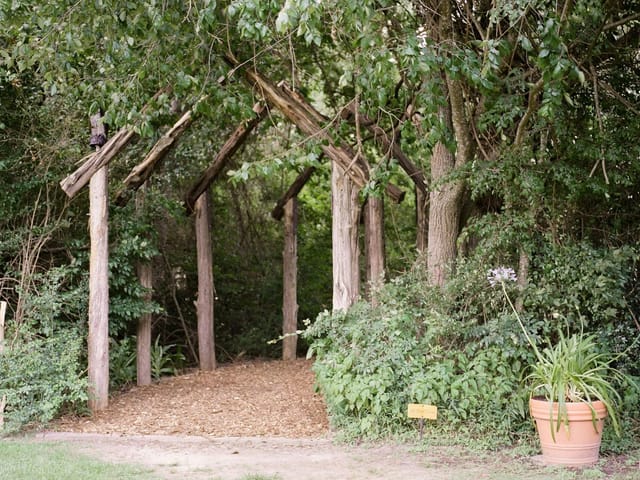 "Bunk House archway with wooden beams, perfect for weddings and retreats."