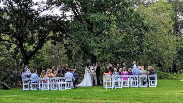 Outdoor wedding ceremony at Houston Arboretum with lush greenery and intimate seating.