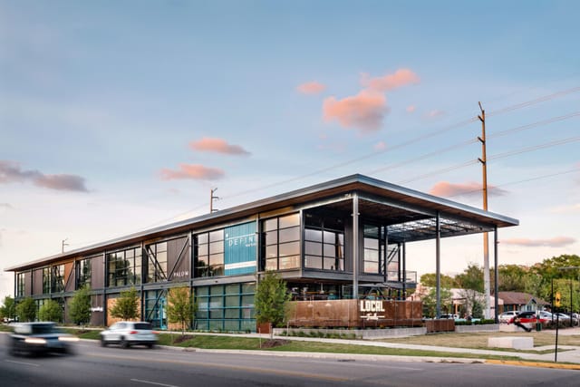 Modern event venue with large glass windows, ideal for gatherings at Heights Mercantile.