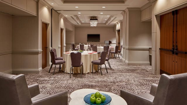 Versatile meeting room in DC City Center, ideal for workshops and events with round tables.