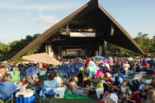 Main Stage at Miller Outdoor Theatre with large crowd enjoying a summer concert event.