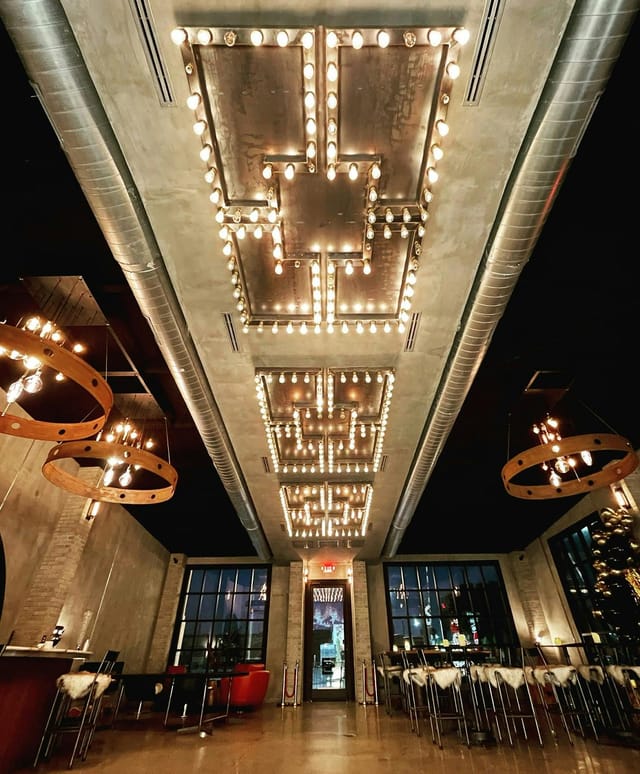 Stylish event space with illuminated ceiling for meetings and receptions.