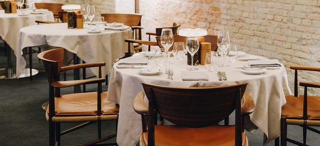 Elegant banquet hall table setting at Admiral Hotel for upscale events and networking dinners.