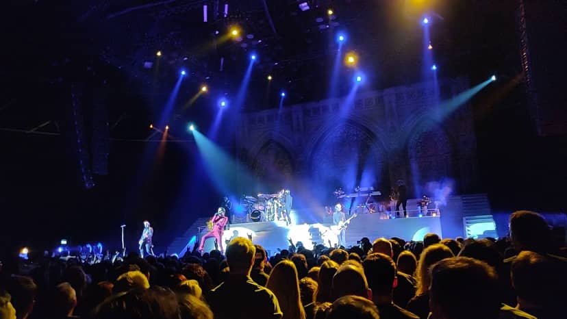 Vibrant Black Box concert scene with dynamic lighting and an engaged audience.