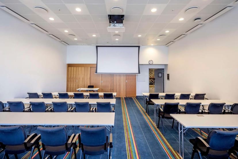 Conference center in Scandic Hotels with projector screen for seminars and workshops.