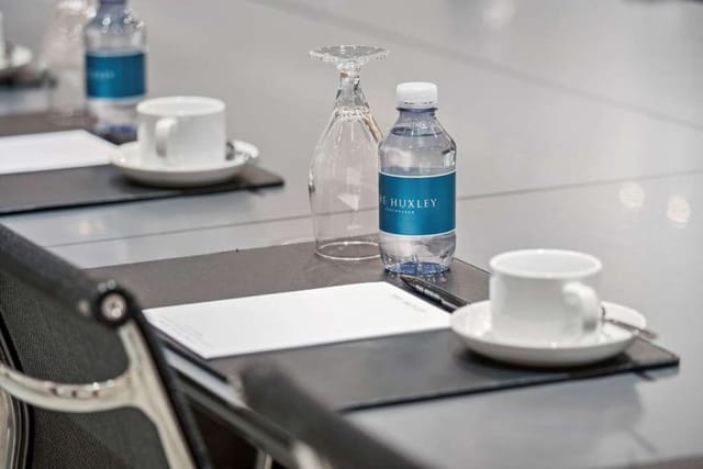 Professional meeting room with branded water bottles, ideal for corporate presentations.
