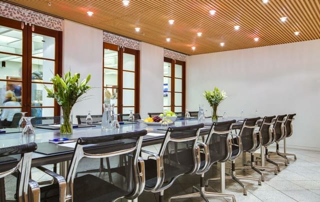Modern conference room at The Huxley with glass table for productive meetings.