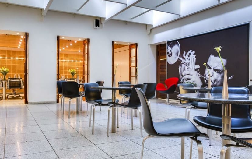 Modern meeting room in The Huxley with sleek furniture, ideal for events or networking.