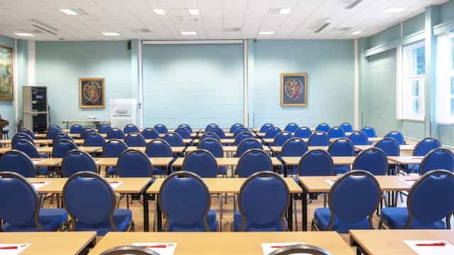 Conference room Olavsalen at Clarion Hotel, featuring blue chairs for seminars.