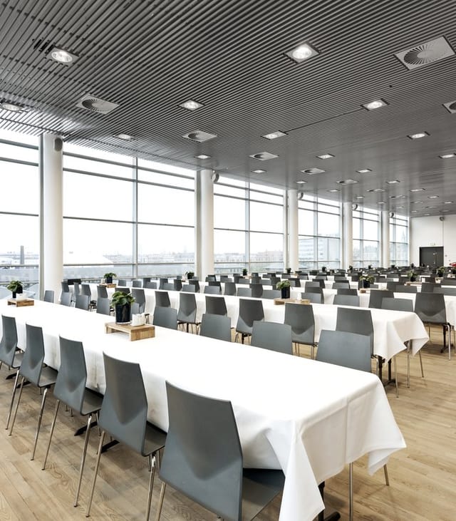 Modern conference room with large windows, ideal for meetings and events.