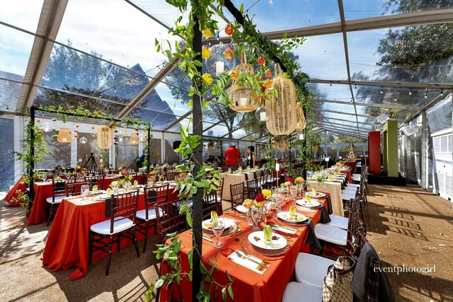 Elegant garden event space with transparent tent, ideal for upscale celebrations.