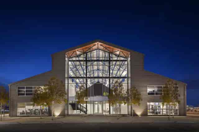 Modern event venue with sleek design and glass windows, ideal for conferences and meetings.