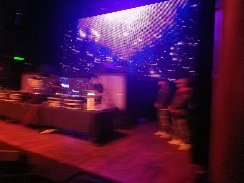 Yost Theater stage with vibrant lighting for a live performance event.