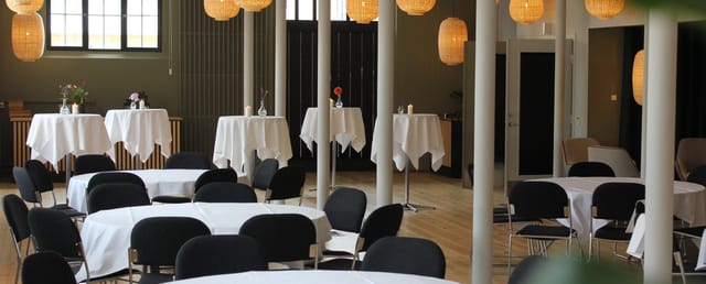 Elegant Spisehuset venue with high-top tables for networking events and receptions.
