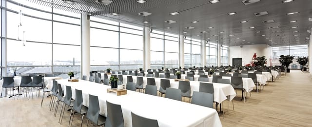 Spisehuset banquet space with elegant tables, ideal for conferences and events.