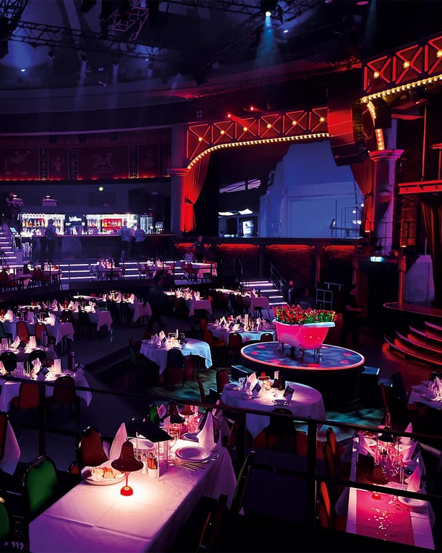 Event management company in Copenhagen exhibition space with elegant table setup.