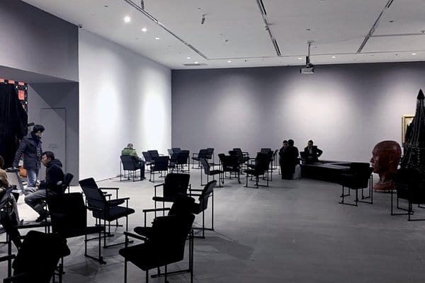 Minimalist small event space with art, perfect for networking and presentations.