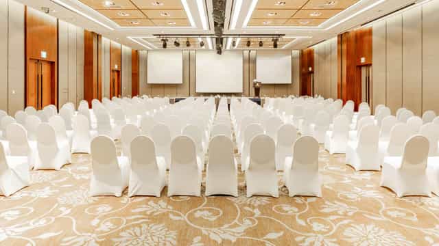 Sapphire Ballroom at LOTTE HOTEL WORLD set for a professional conference with white chairs.