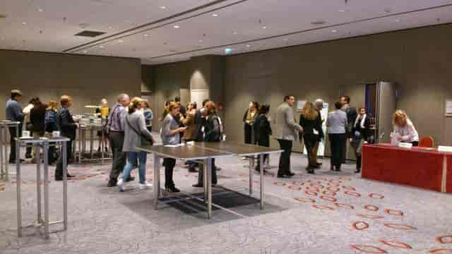 Networking event in Studio J at Paris Marriott, featuring engaging conversations and spacious layout.