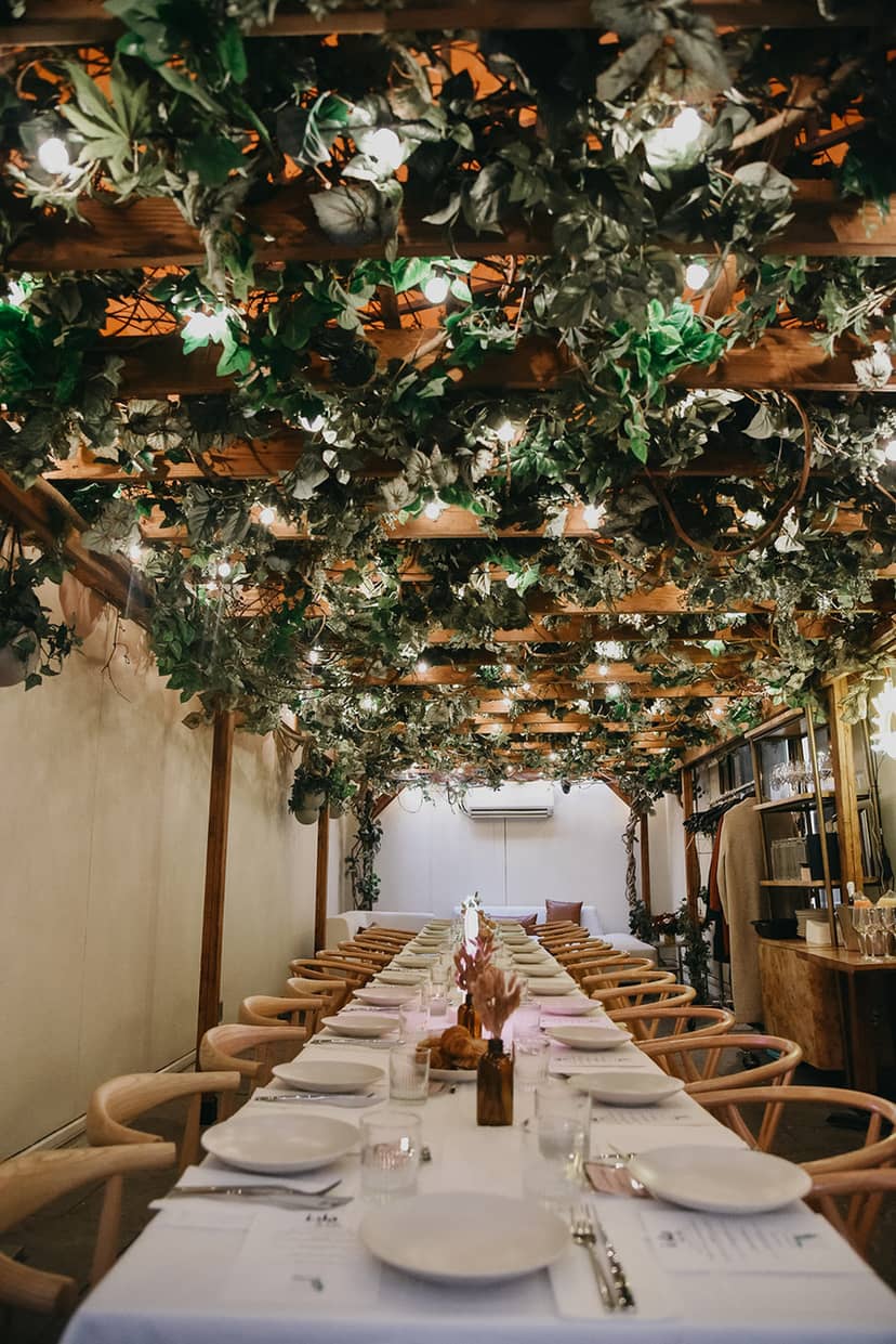 Private dining room at Isla & Co. Midtown, featuring lush greenery for elegant events.